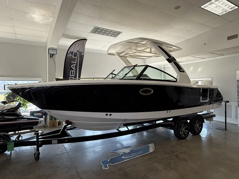 Slide: The Image of 2026 Robalo 257 Dual Console boat in showroom. - 2