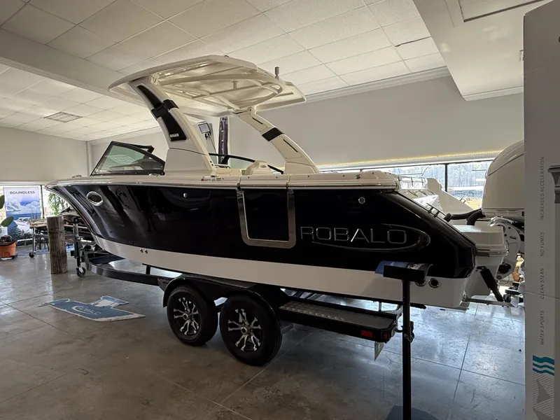 Slide: The Image of 2026 Robalo 257 Dual Console boat in showroom. - 3