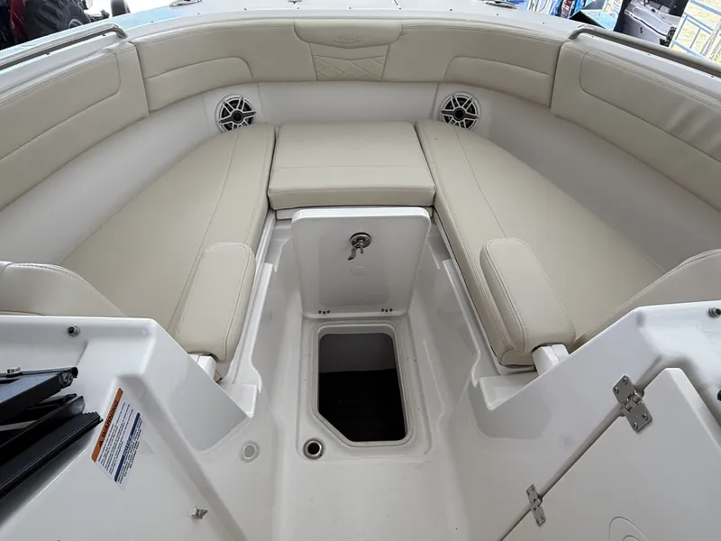 Slide: The Image of Interior of 2026 Robalo 257 Dual Console with beige seating. - 5