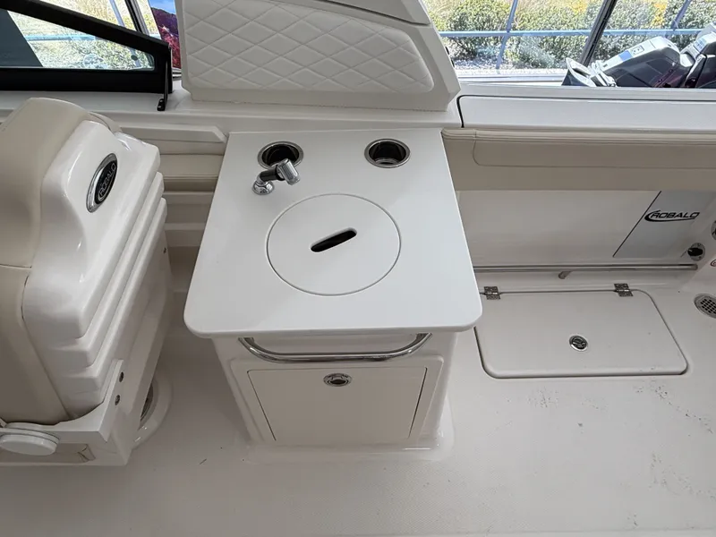 Slide: The Image of Interior of 2026 Robalo 257 Dual Console with sink and storage. - 8