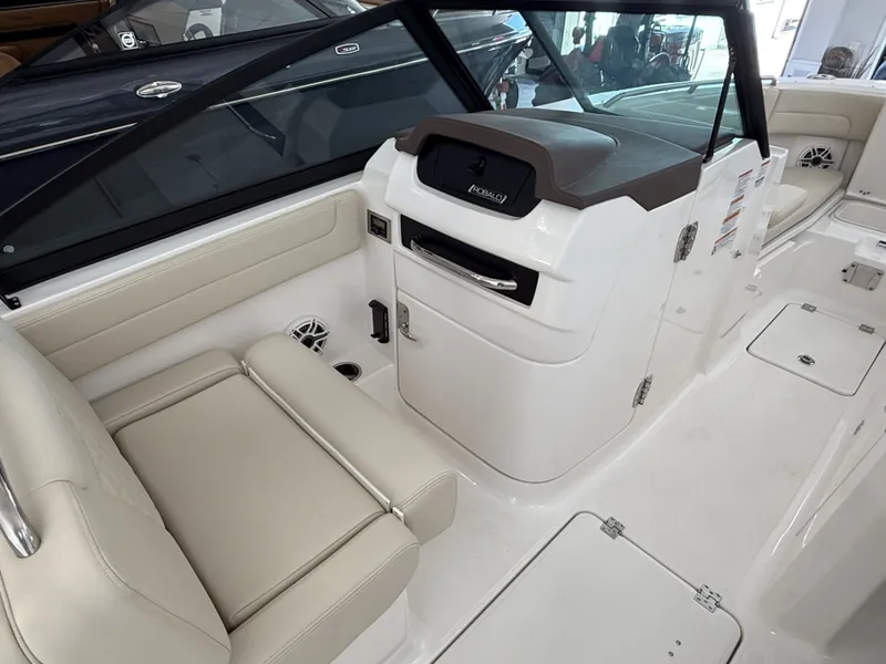 Slide: The Image of Interior of 2026 Robalo 257 Dual Console with beige seating. - 9
