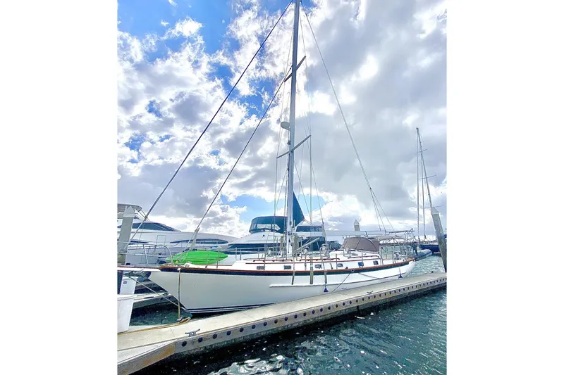 The Image of Cabo Rico Cutter 45 sailboat docked under cloudy sky, 2000 model. - 0