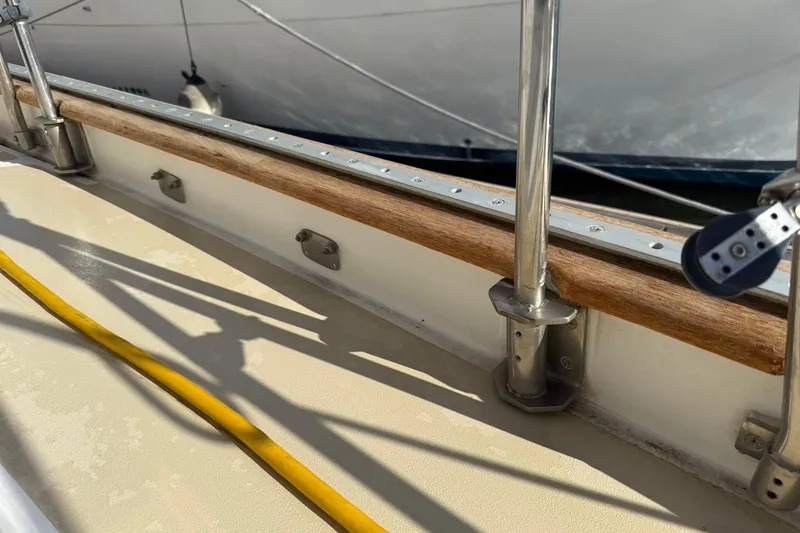 Slide: The Image of Cabo Rico Cutter 45 (2000) deck detail with railing and yellow cable. - 12