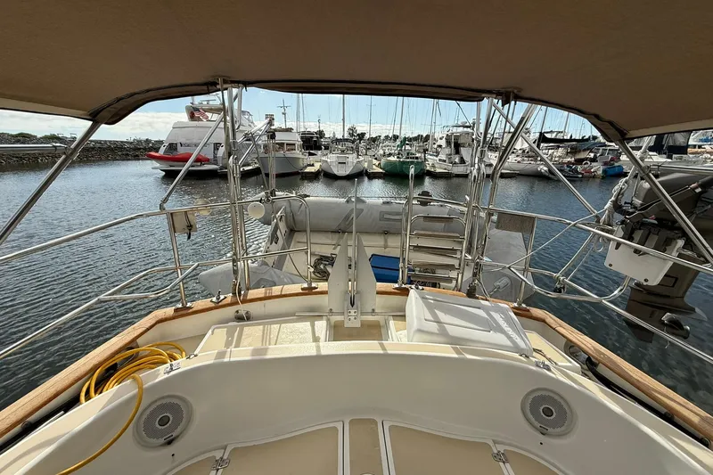 Slide: The Image of Cabo Rico Cutter 45 sailboat, 2000 model, docked in a marina with other boats. - 17