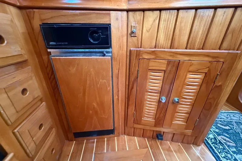 Slide: The Image of Wooden interior of 2000 Cabo Rico Cutter 45 with built-in trash compactor. - 27