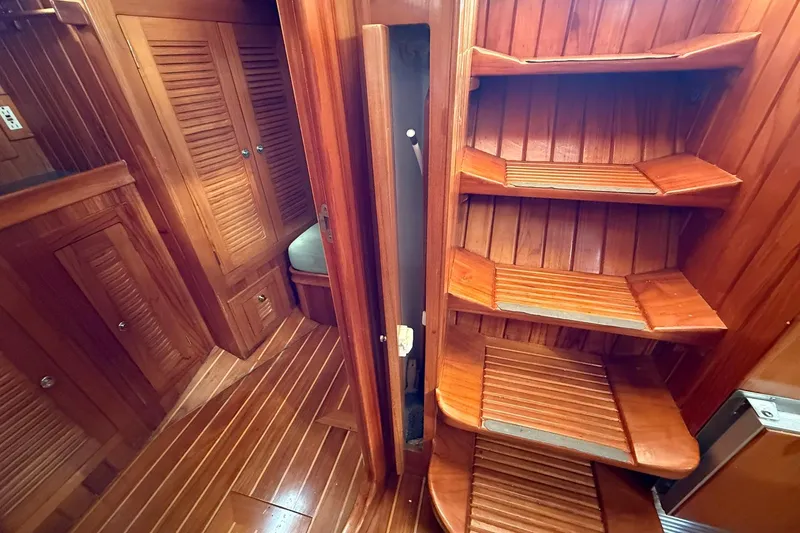 Slide: The Image of Interior of 2000 Cabo Rico Cutter 45, featuring wooden stairs and cabinetry. - 28