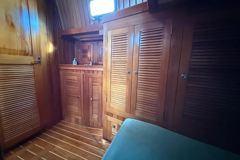 Slide: The Image of Interior of 2000 Cabo Rico Cutter 45 with wooden cabinetry and cozy design. - 31