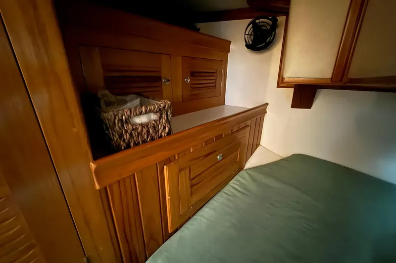 Slide: The Image of Cabo Rico Cutter 45 (2000) interior with wooden cabinetry and storage basket. - 33