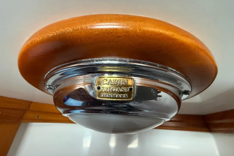 Slide: The Image of Cabo Rico Cutter 45 (2000) cabin light fixture with wooden and metal design. - 37