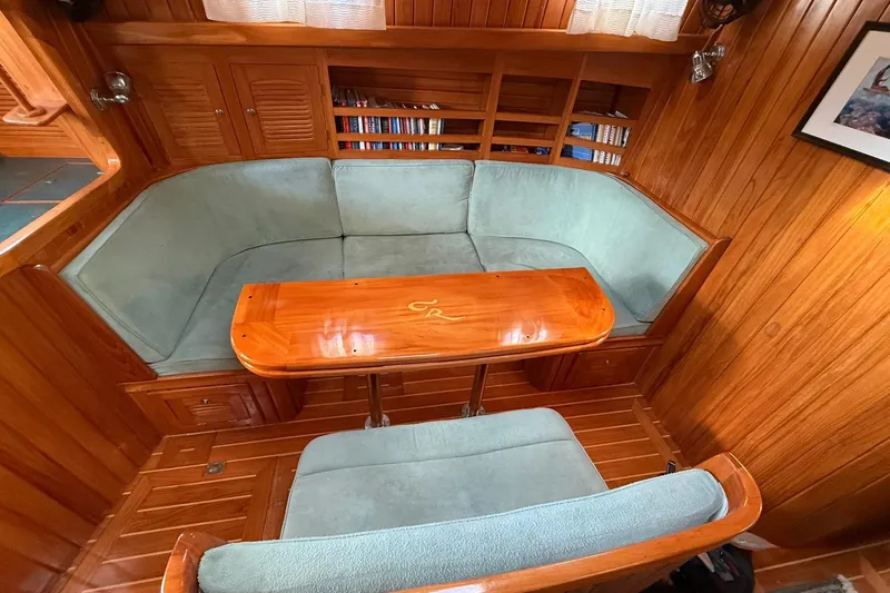 Slide: The Image of Cabo Rico Cutter 45 (2000) interior with wooden paneling and cozy seating area. - 38