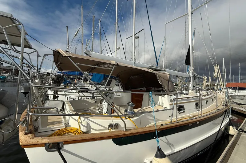 Slide: The Image of Cabo Rico Cutter 45 sailboat, 2000 model, docked at marina under cloudy sky. - 4