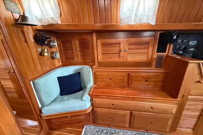 Slide: The Image of Interior of 2000 Cabo Rico Cutter 45 with wooden cabinetry and cozy seating area. - 41