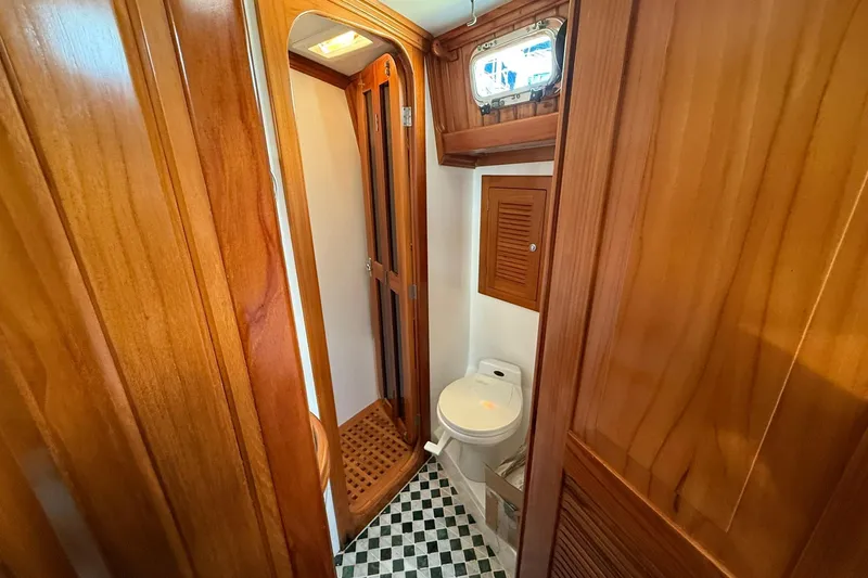 Slide: The Image of Cabo Rico Cutter 45 (2000) yacht bathroom with wooden interior and checkered floor. - 42