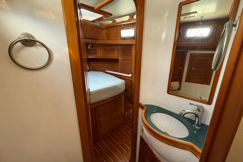 Slide: The Image of Cabo Rico Cutter 45 yacht interior, featuring a cozy cabin and elegant bathroom, 2000 model. - 44