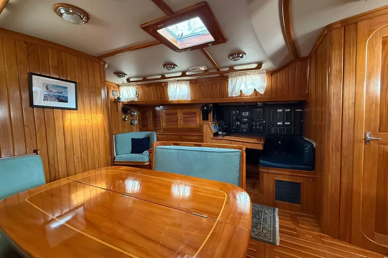 Slide: The Image of Luxurious interior of 2000 Cabo Rico Cutter 45 sailboat with wood paneling and seating. - 48