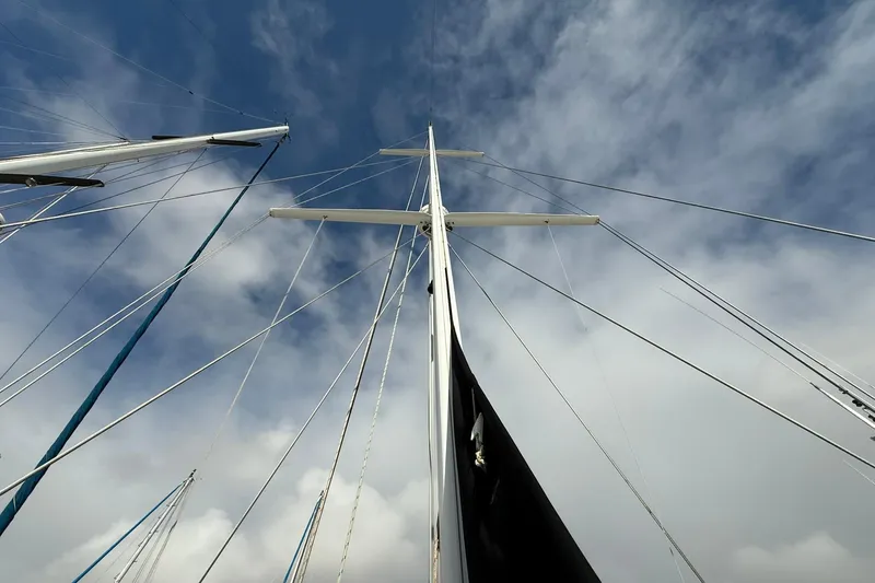 Slide: The Image of Mast and rigging of 2000 Cabo Rico Cutter 45 sailboat against cloudy sky. - 5