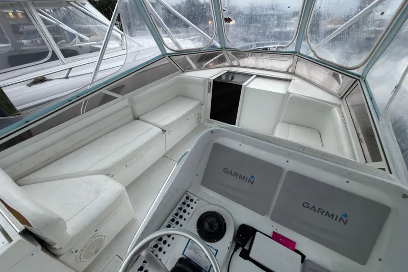Slide: The Image of 2002 Contender 35 Express Side Console interior with Garmin navigation system and seating area. - 5
