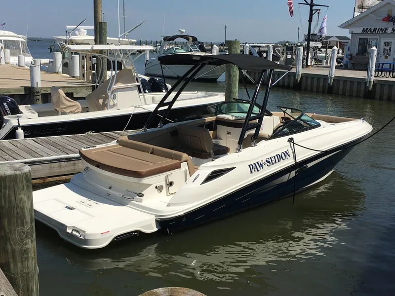 The Image of 2017 Sea Ray SDX 240 boat docked at marina, featuring sleek design and spacious seating. - 0
