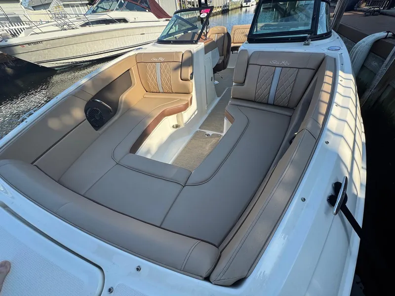 Slide: The Image of 2017 Sea Ray SDX 240 boat interior with tan seating and elegant design. - 10
