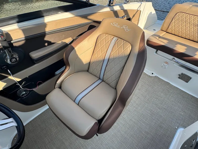 Slide: The Image of 2017 Sea Ray SDX 240 boat interior with luxurious tan and brown seating. - 11