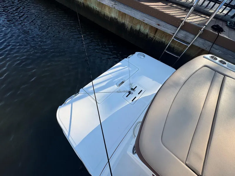 Slide: The Image of 2017 Sea Ray SDX 240 boat docked, showing rear seating and swim platform. - 14