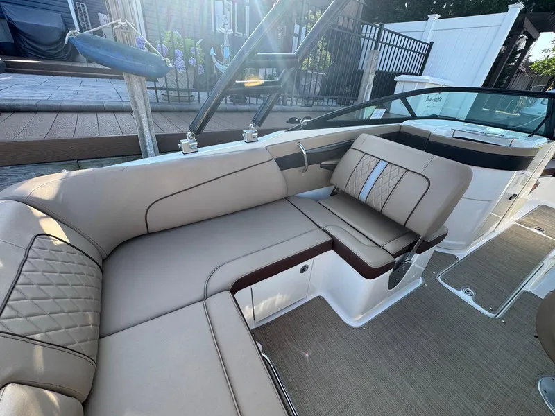 Slide: The Image of 2017 Sea Ray SDX 240 boat interior with beige seating and modern design. - 16