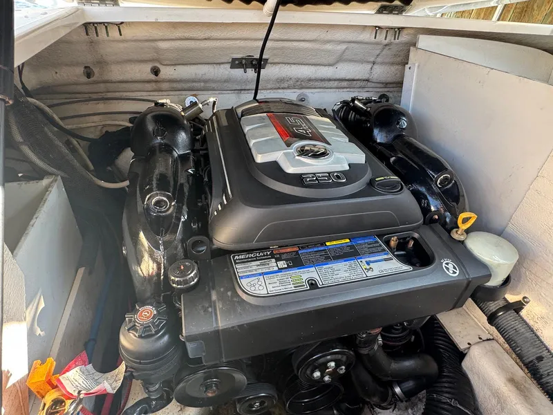 Slide: The Image of Engine compartment of a 2017 Sea Ray SDX 240 boat, featuring a Mercury 4.5L 250 engine. - 21
