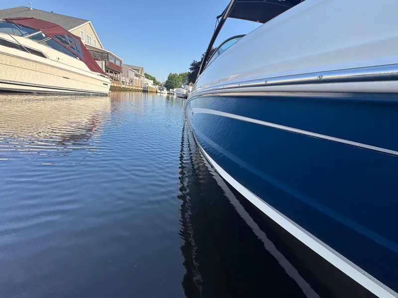 Slide: The Image of 2017 Sea Ray SDX 240 boat docked in calm waters, residential backdrop. - 4
