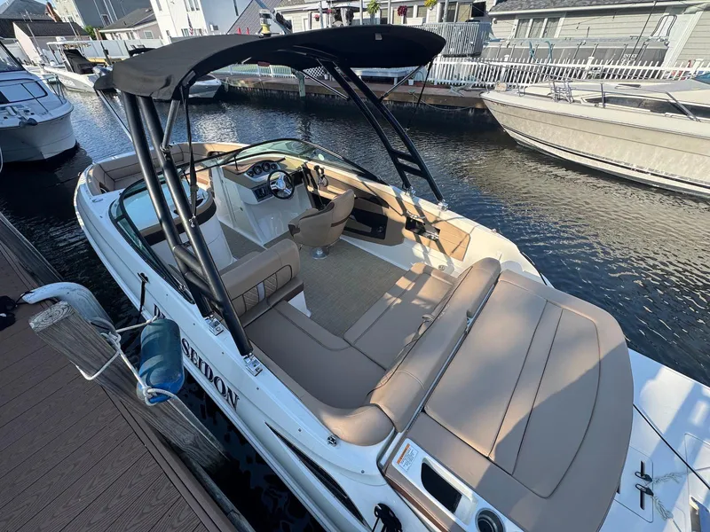 Slide: The Image of 2017 Sea Ray SDX 240 boat docked, featuring spacious seating and sleek design. - 5