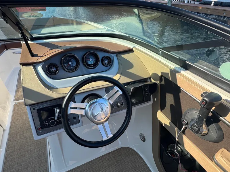 Slide: The Image of 2017 Sea Ray SDX 240 boat dashboard with steering wheel and control panel. - 8