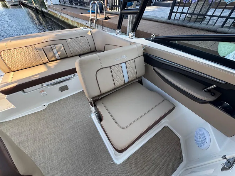 Slide: The Image of 2017 Sea Ray SDX 240 boat interior with beige seating and elegant design. - 9