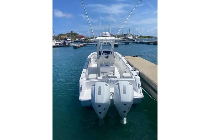 Slide: The Image of 2022 Streamline 26 boat docked in marina with twin outboard engines. - 3