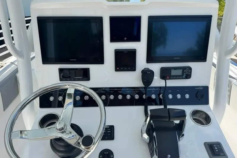 Slide: The Image of Control panel of 2022 Streamline 26 boat with steering wheel and electronic displays. - 6