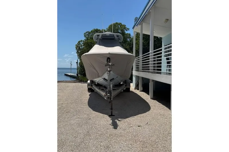 Slide: The Image of Covered 2022 Streamline 26 boat on trailer near waterfront. - 8