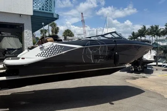 The Image of 2023 Scarab 215 ID boat on trailer under cloudy sky at dealership. - 0