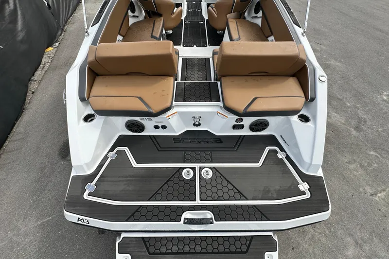 Slide: The Image of 2023 Scarab 215 ID boat interior with tan seating and black flooring. - 11