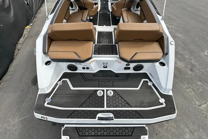 Slide: The Image of 2023 Scarab 215 ID boat interior with tan seating and black flooring. - 12