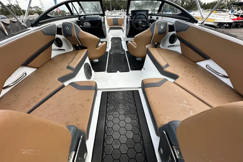 Slide: The Image of 2023 Scarab 215 ID boat interior with tan seating and modern dashboard design. - 17