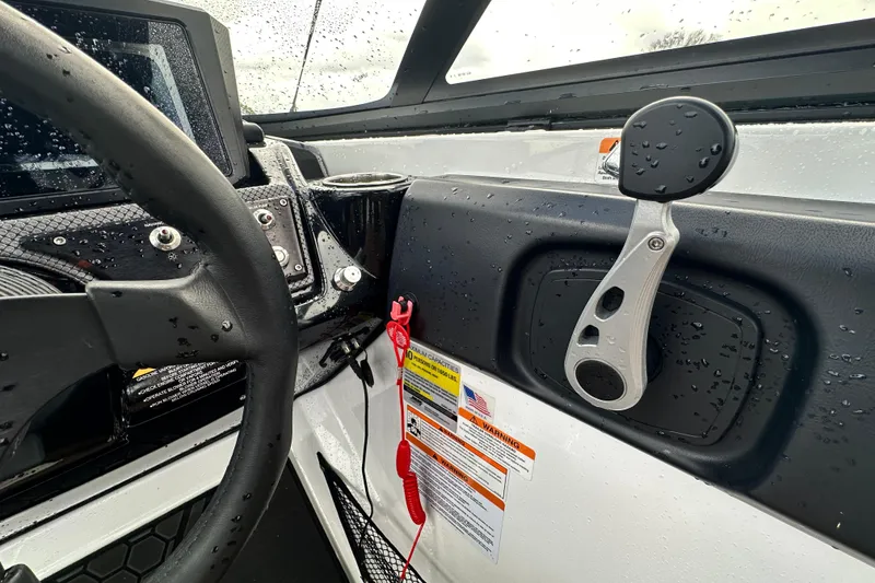 Slide: The Image of Close-up of 2023 Scarab 215 ID boat dashboard with steering wheel and controls. - 29