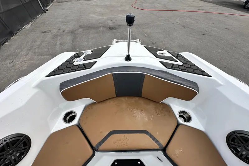 Slide: The Image of 2023 Scarab 215 ID boat interior with tan seating and black accents. - 38