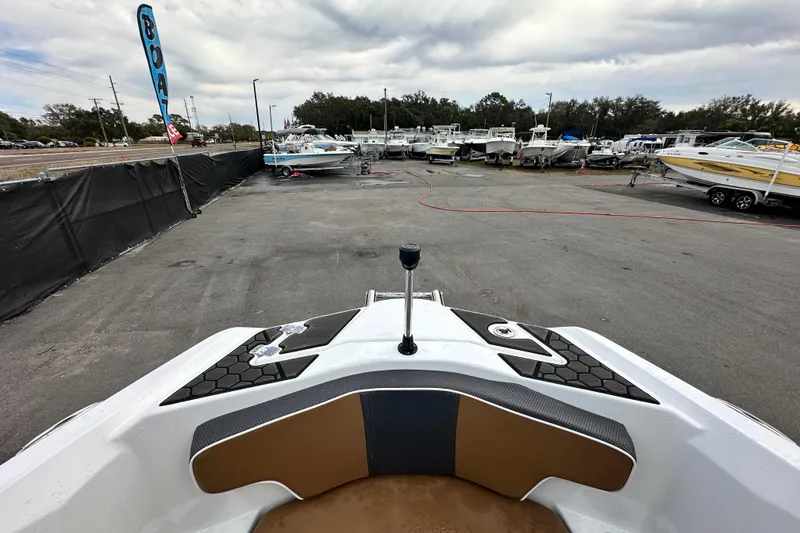 Slide: The Image of 2023 Scarab 215 ID boat at a dealership with other boats in the background. - 39