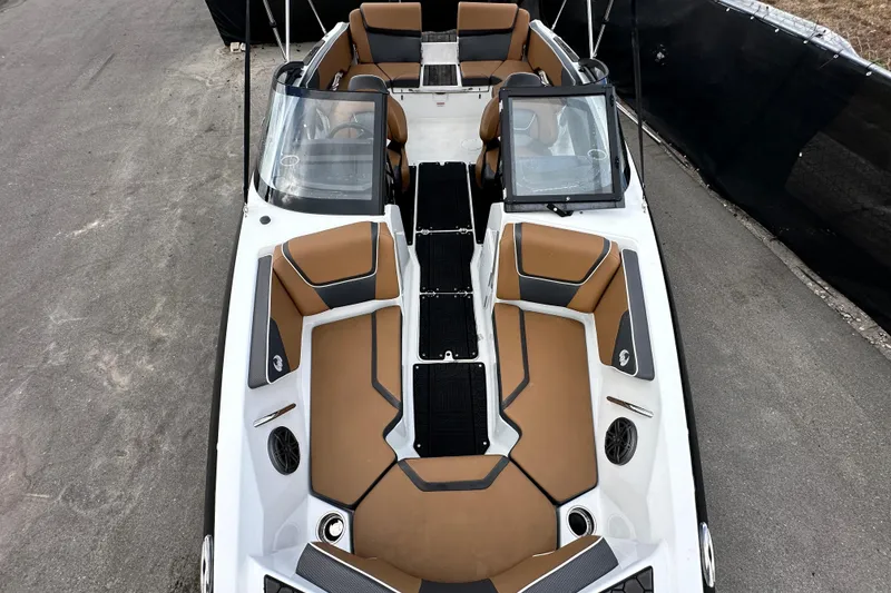 Slide: The Image of 2023 Scarab 215 ID boat interior with tan and black seating, viewed from above. - 45
