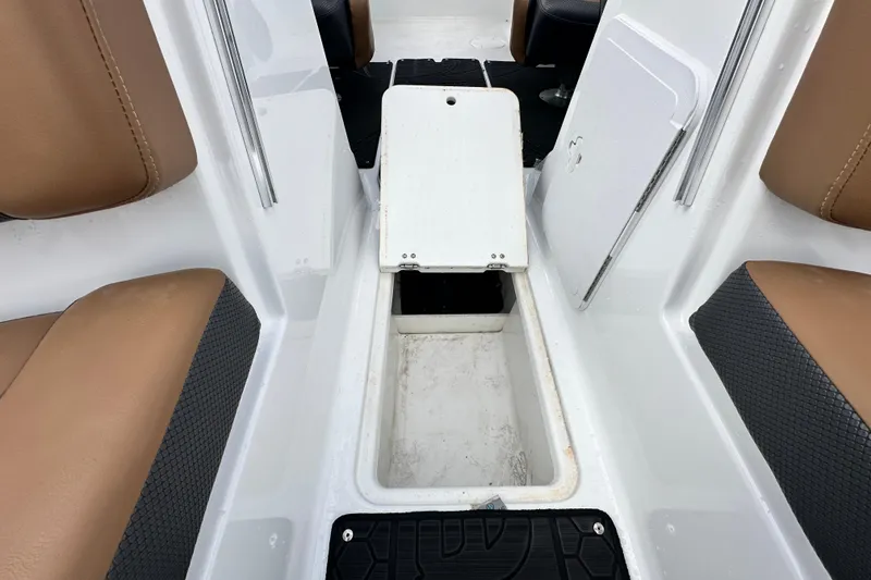 Slide: The Image of 2023 Scarab 215 ID boat interior with storage compartment and tan seating. - 50