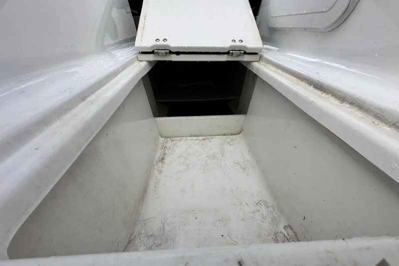 Slide: The Image of 2023 Scarab 215 ID boat storage compartment, white interior, open hatch. - 51