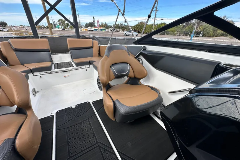 Slide: The Image of 2023 Scarab 215 ID boat interior with tan and gray seating, modern design. - 53