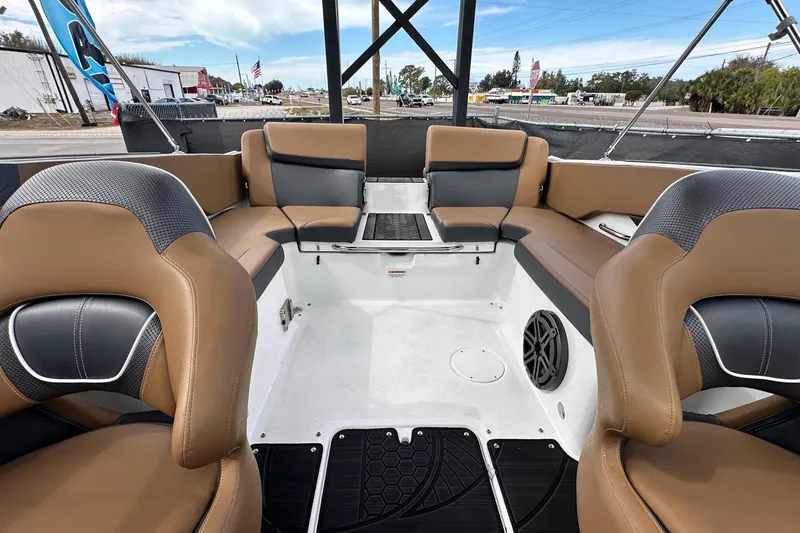 Slide: The Image of 2023 Scarab 215 ID boat interior with tan and black seating, modern design. - 55