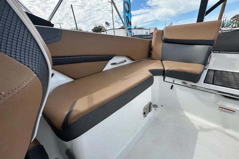 Slide: The Image of 2023 Scarab 215 ID boat interior with brown and black seating, showcasing modern design. - 57