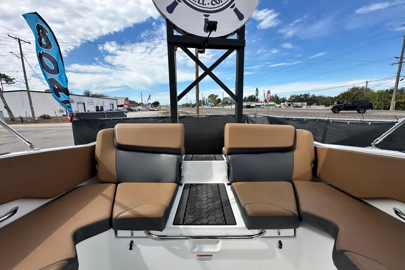 Slide: The Image of 2023 Scarab 215 ID boat interior with tan seating and open deck view. - 61