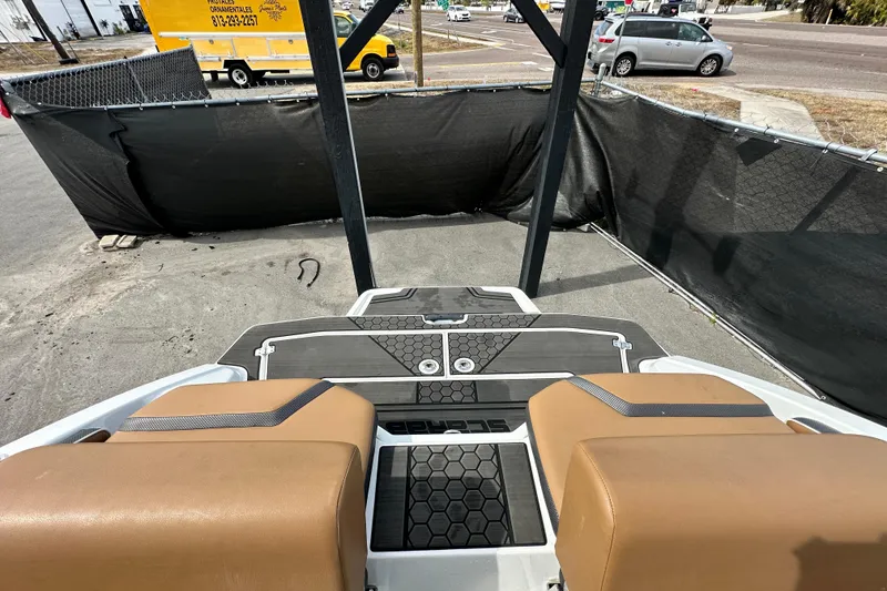 Slide: The Image of 2023 Scarab 215 ID boat interior with tan seats and black flooring. - 64