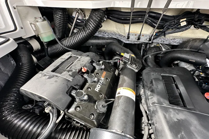 Slide: The Image of Engine compartment of 2023 Scarab 215 ID boat, featuring Rotax engine components. - 68
